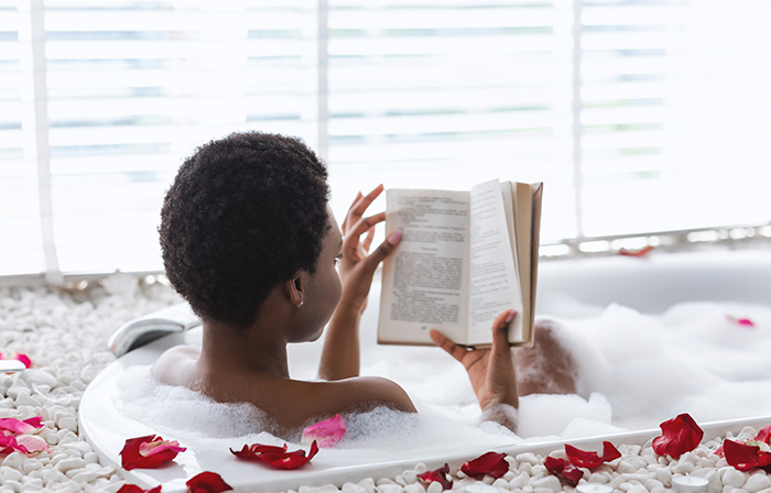 Black woman reading in the bath