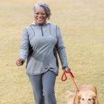 african american woman walking her dog